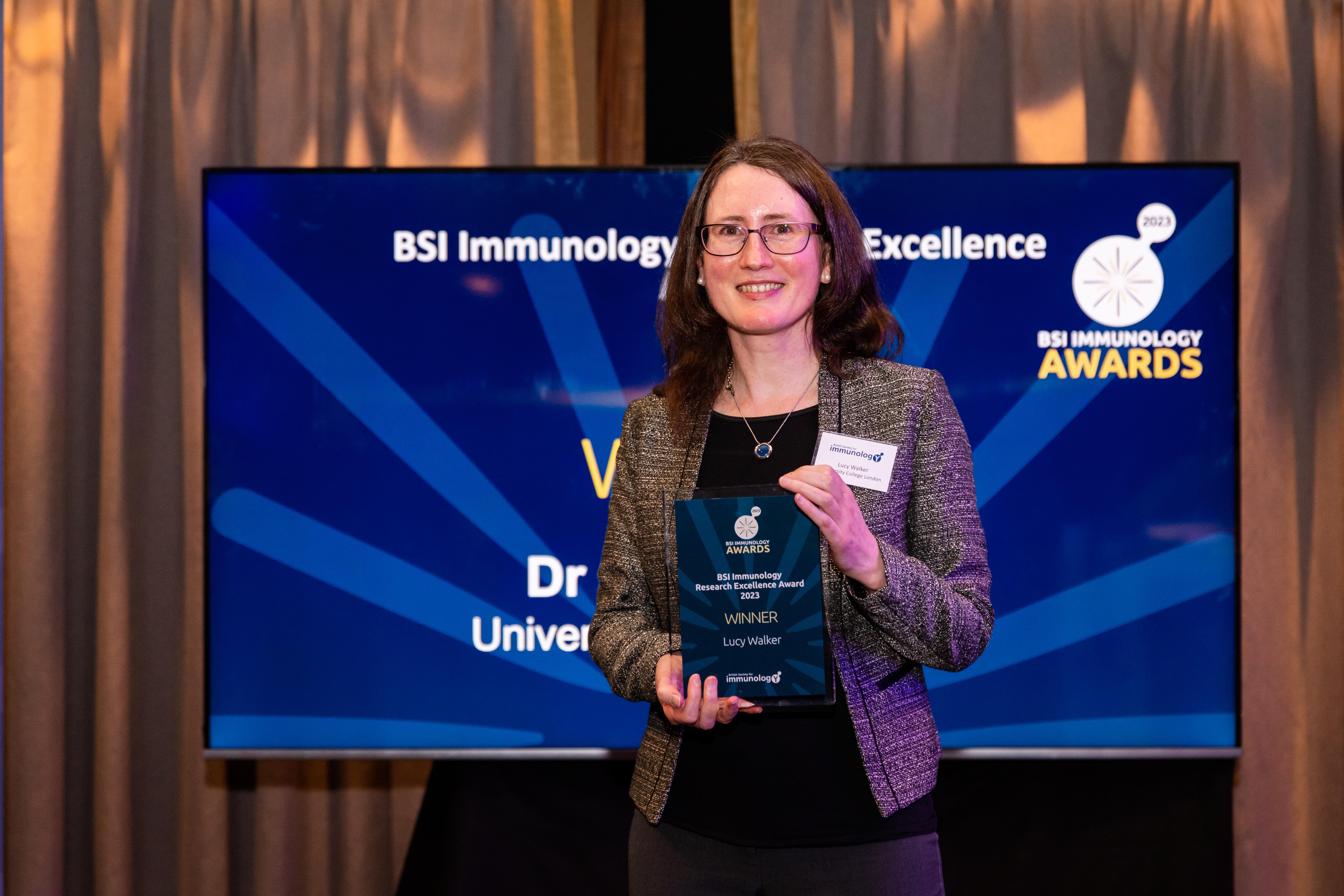 Professor Lucy Walker holding her award