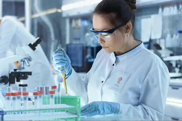 Female scientist using micropipette