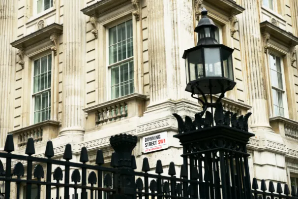 downing street street sign corner with fence and street lamp